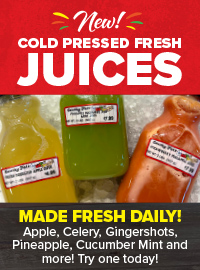 Cold-pressed fresh juices with yellow, green, and orange bottles on ice.